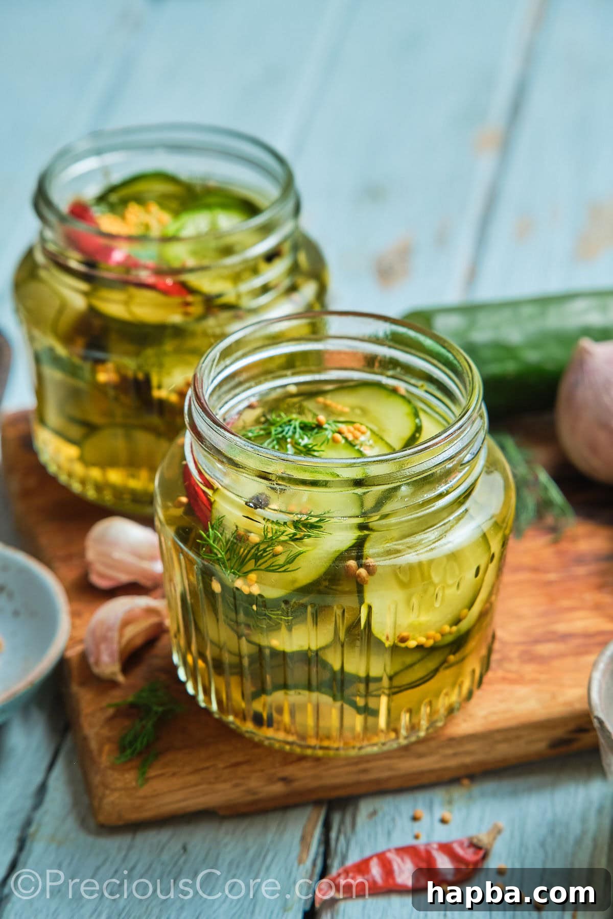 Speedy Zesty Pickles 11 Two mason jars of homemade quick pickled cucumbers.