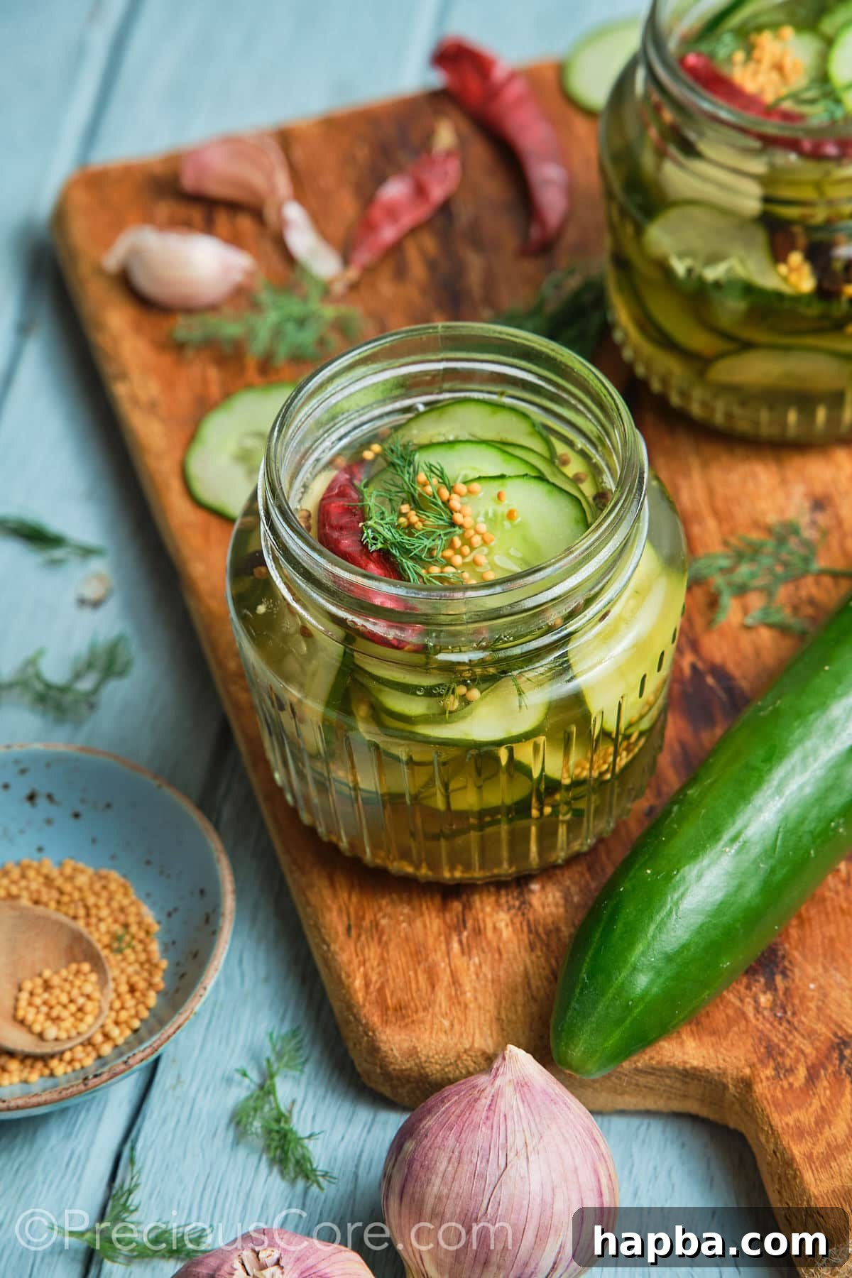 Speedy Zesty Pickles 3 Wide shot showing cucumbers in a jar and other ingredients all around it.