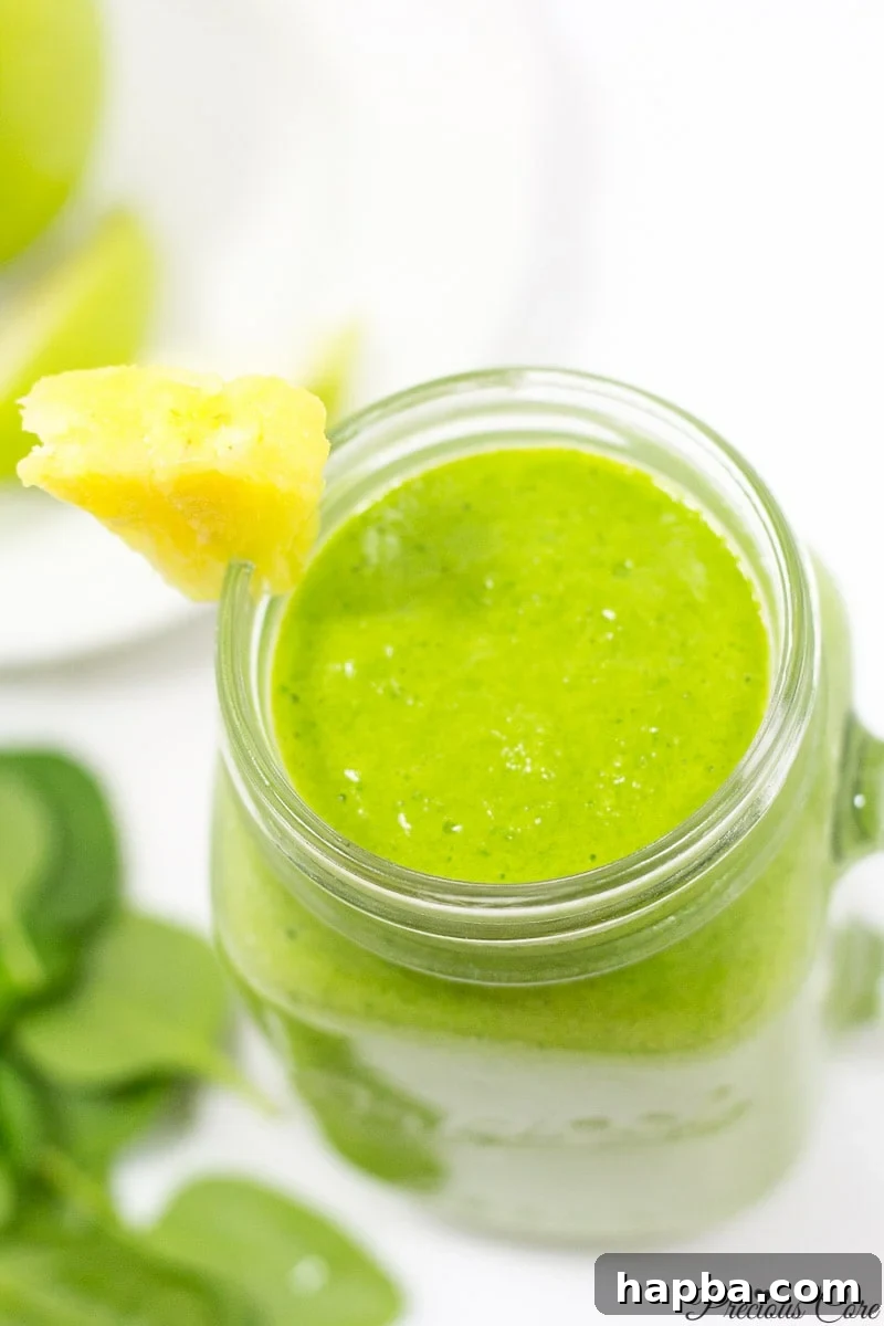 A vibrant green spinach smoothie served in a modern glass, signaling health and natural goodness.