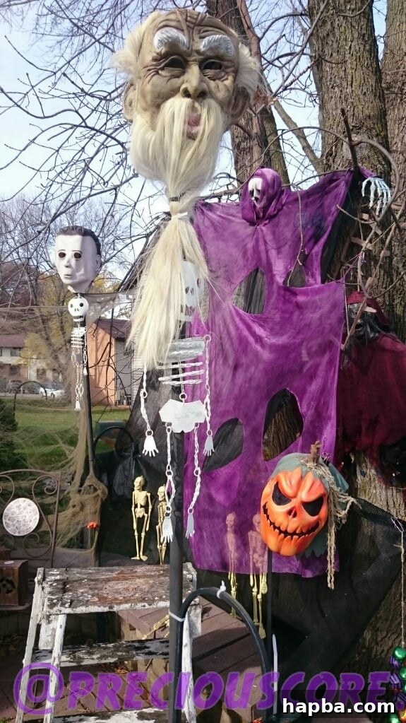 Spooky Photo Roundup 3 A Halloween decorated house with glowing eyes, ghosts, and spider webs.