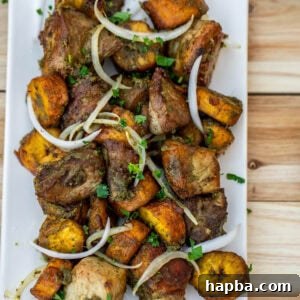Fried pork and plantains topped with sliced onions.