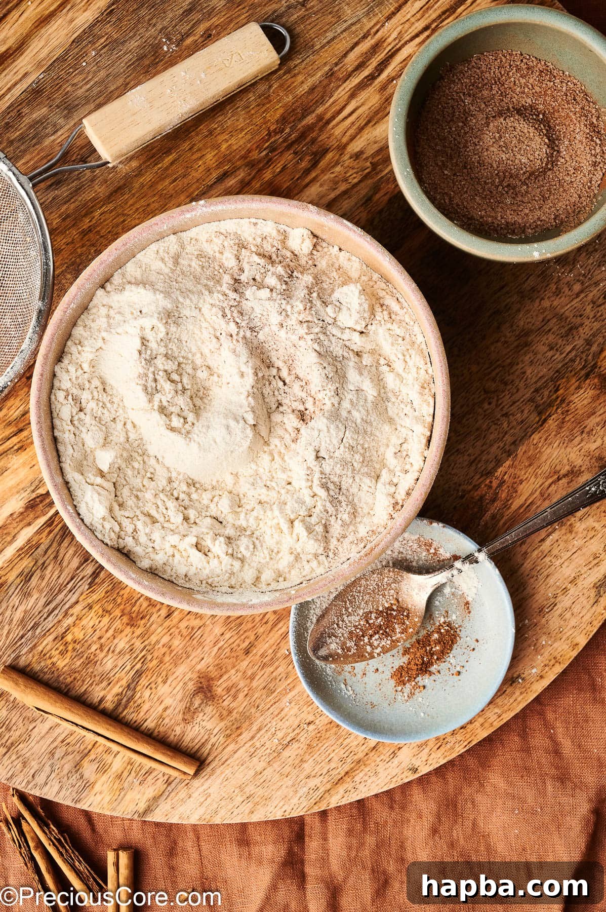 Close-up of sifted flour and dry ingredients in a bowl, showing their uniform texture.