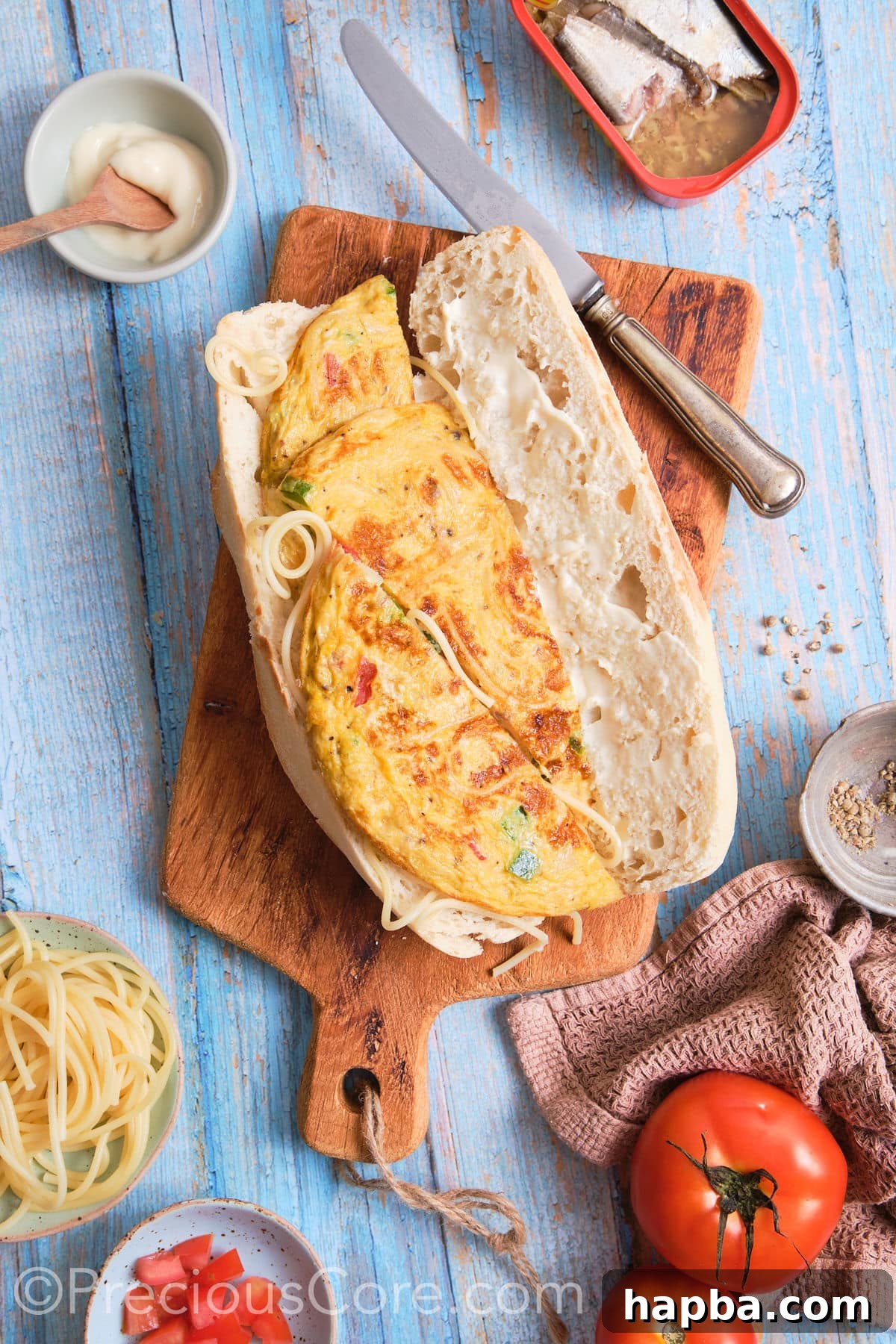 A freshly baked French baguette opened up, with one side prepared to receive the omelette filling.