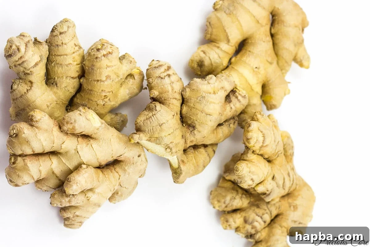 Fresh ginger root on a cutting board, emphasizing the natural ingredients used in the drink, from Precious Core.
