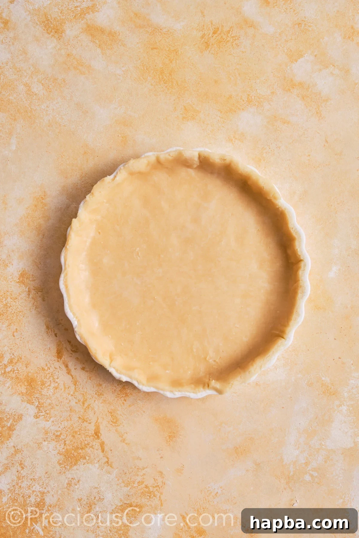Pumpkin pie dough fitted into pie dish.