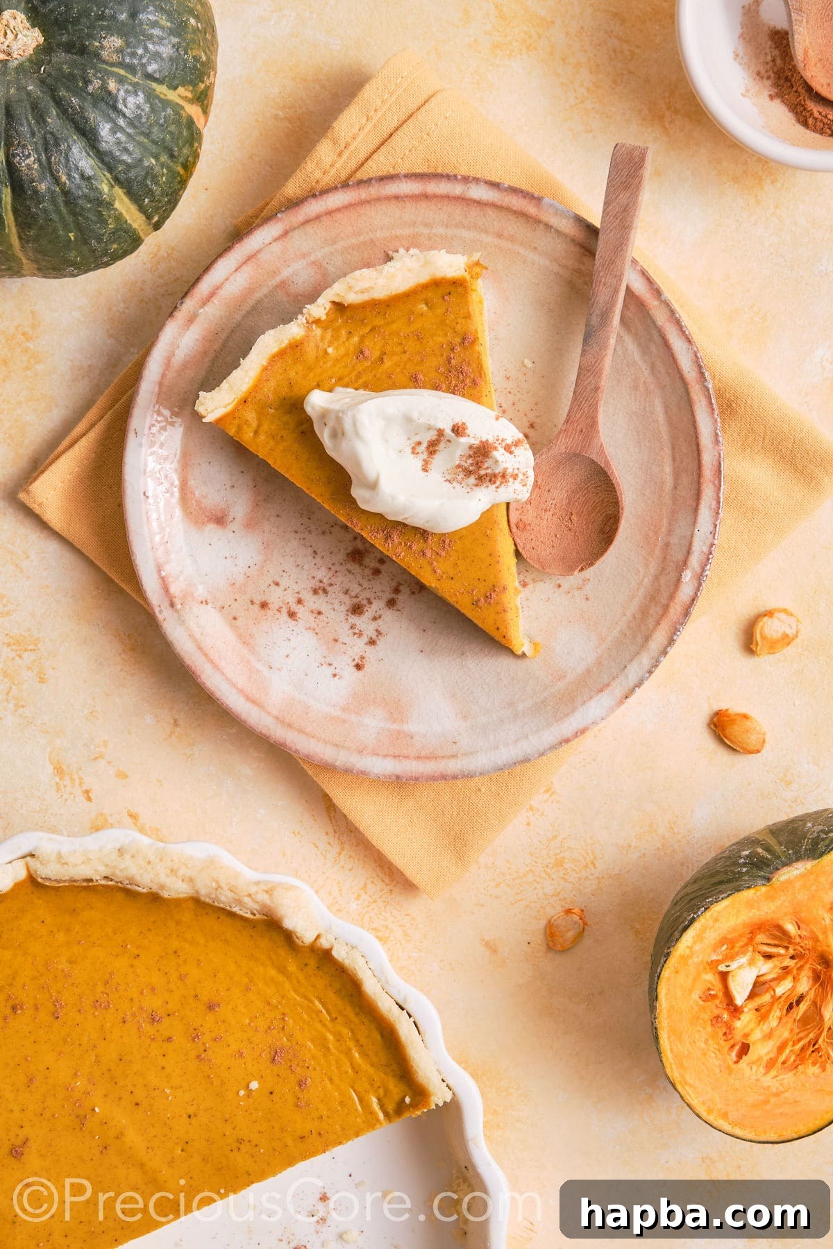 Slice of homemade pumpkin pie served with cream.
