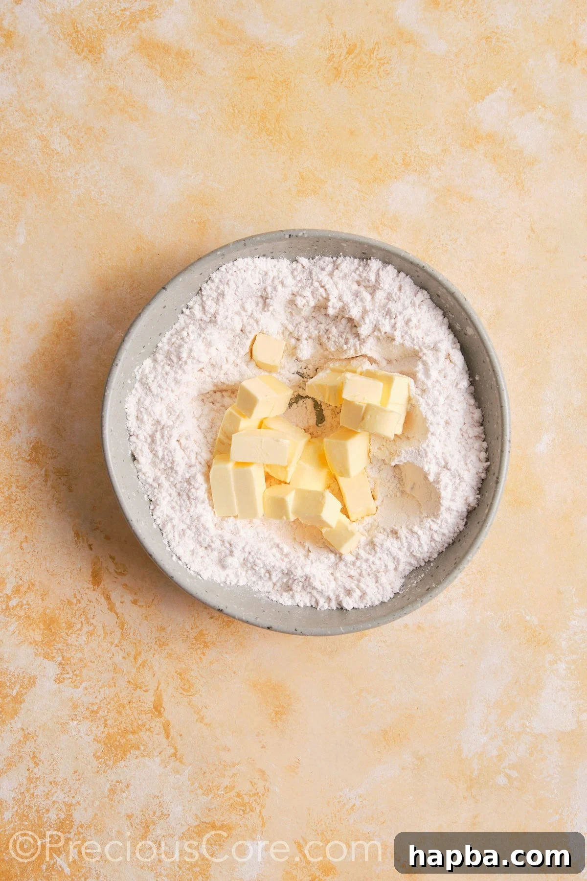 Dry ingredients and butter  for pie crust in a bowl.