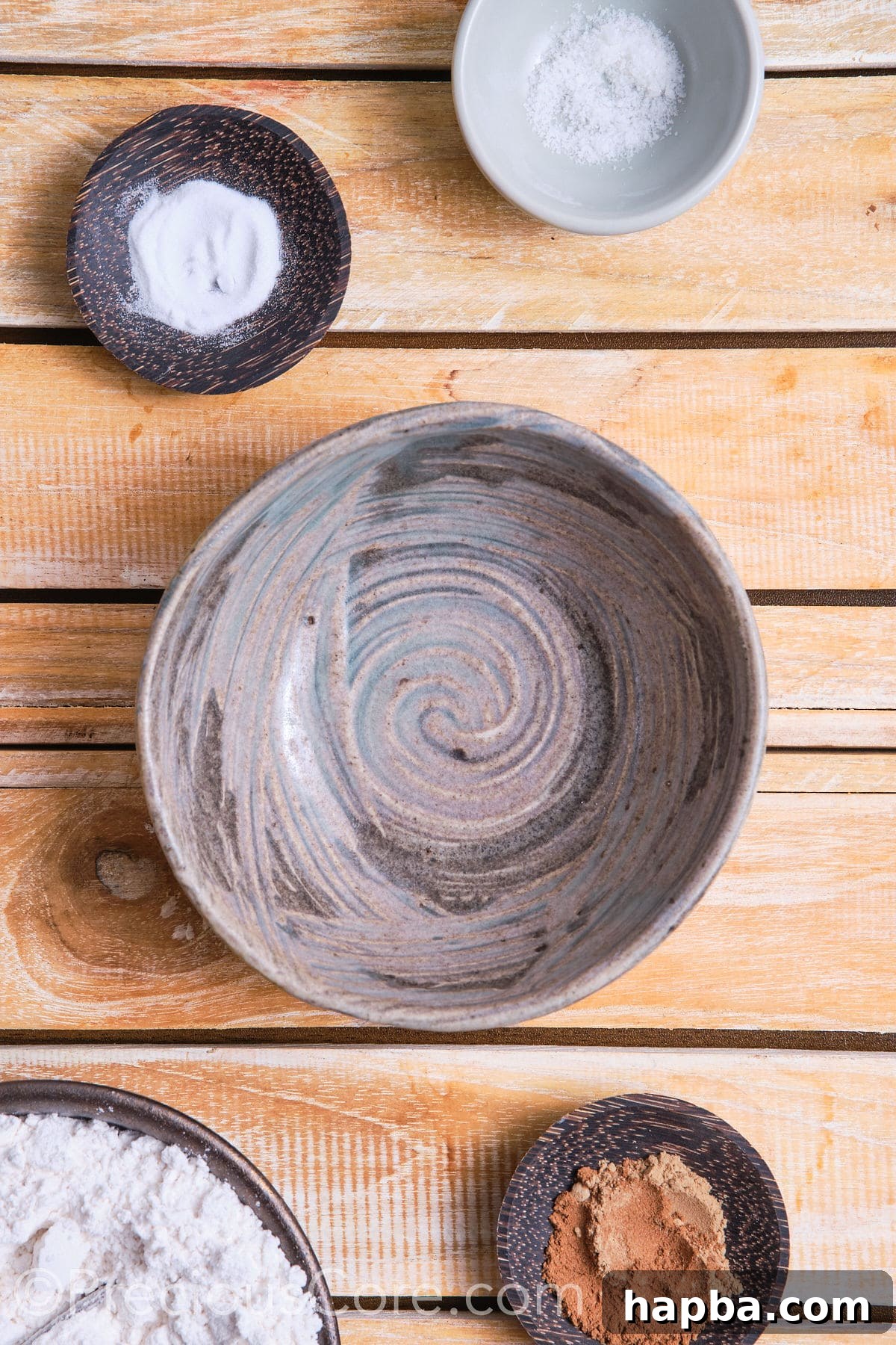 A mixing bowl filled with dry ingredients for chocolate chip cinnamon cookies.