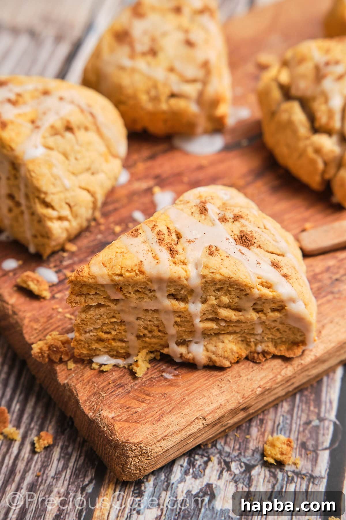 Golden Sweet Potato Scones 2 A perfectly triangular sweet potato scone, glazed with a delicate white icing, ready to be enjoyed.