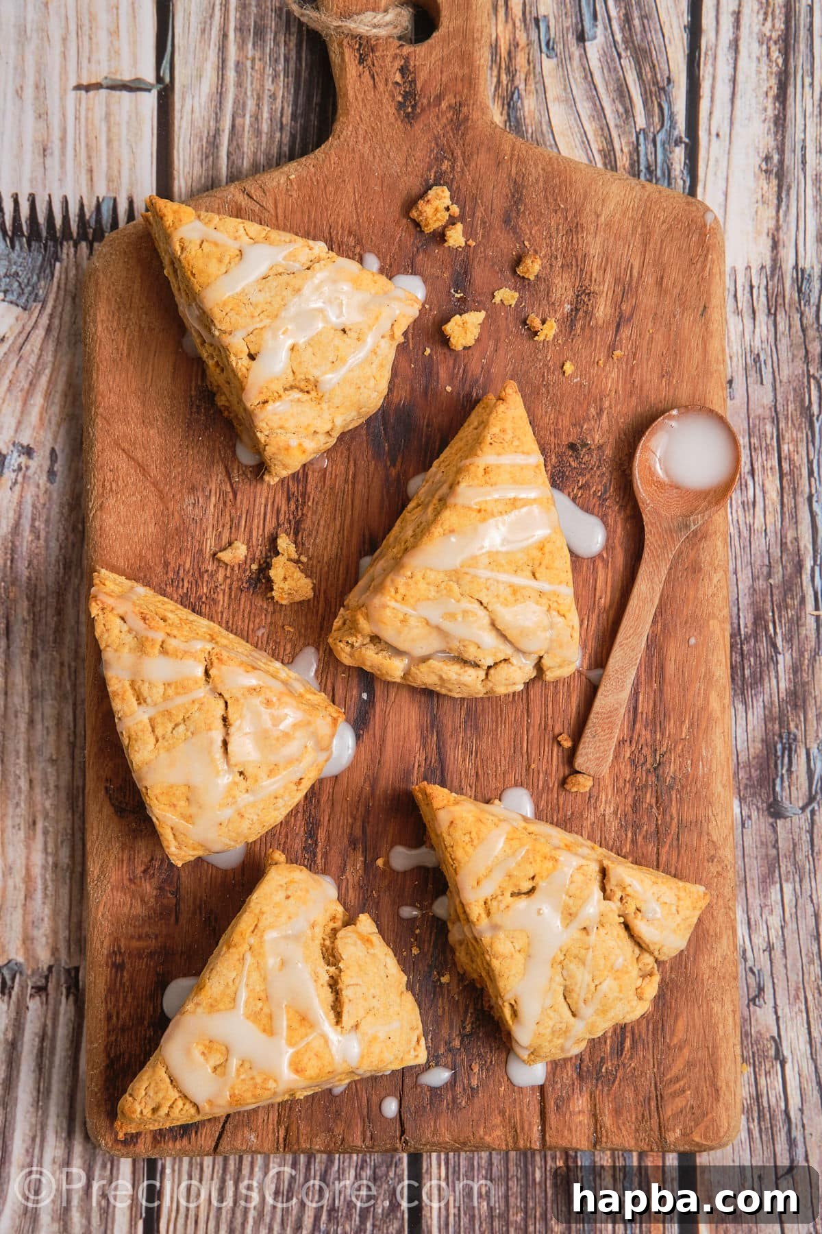 Golden Sweet Potato Scones 19 A stunning arrangement of sweet potato scones with white glaze artfully drizzled on top, showcasing their visual appeal.