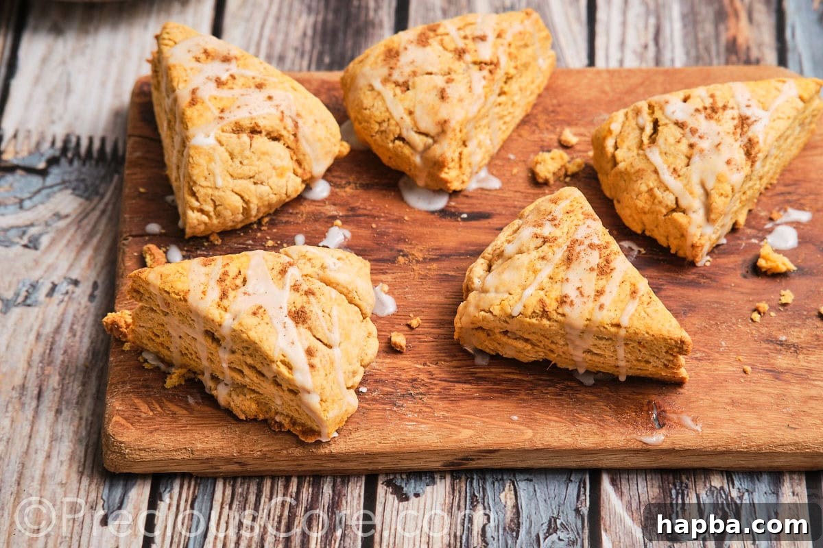 Golden Sweet Potato Scones 20 A collection of homemade sweet potato scones arranged invitingly on a wooden chopping board, emphasizing their rustic charm.