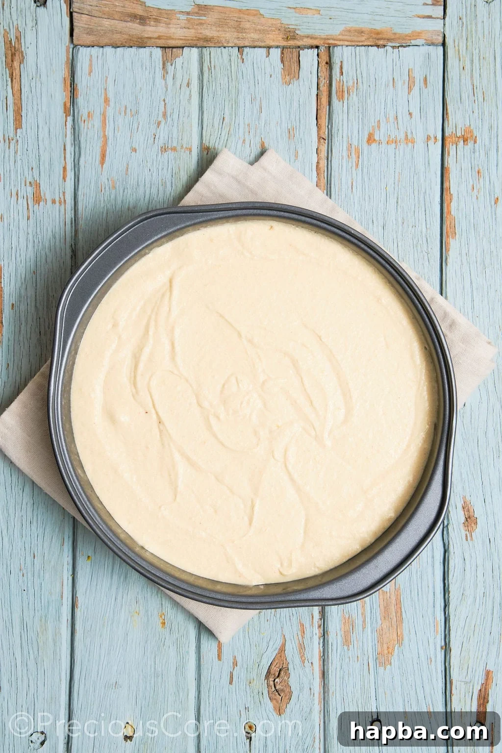 cake batter for the almond and pear cake in a cake pan. 