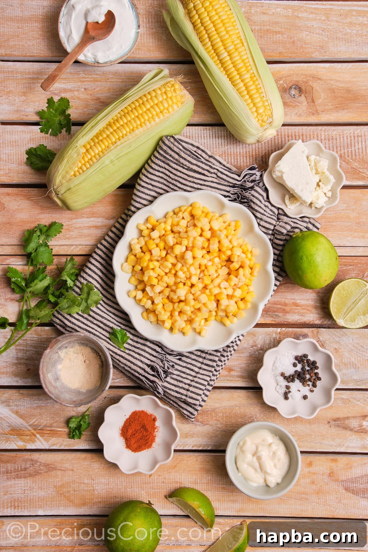 Creamy Elote Bake 3 A selection of fresh ingredients including corn, sour cream, mayonnaise, queso fresco, and spices for street corn casserole.