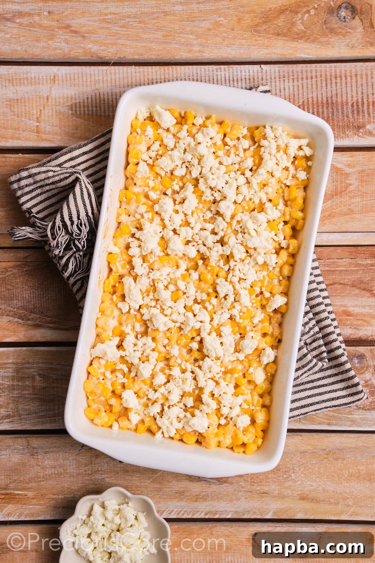 Creamy Elote Bake 7 Freshly baked corn casserole topped with crumbled queso fresco, melting slightly from the heat.