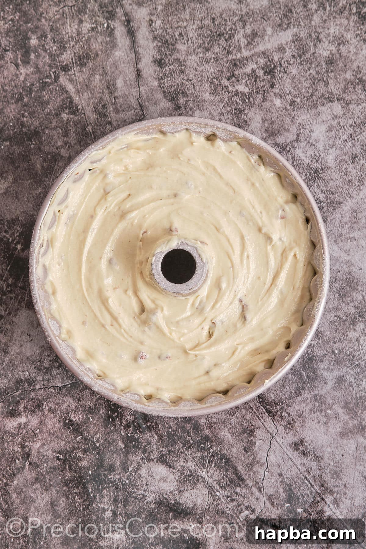 Decadent Butter Pecan Pound Cake 11 Pouring the cake batter into the prepared Bundt pan, ready for baking.
