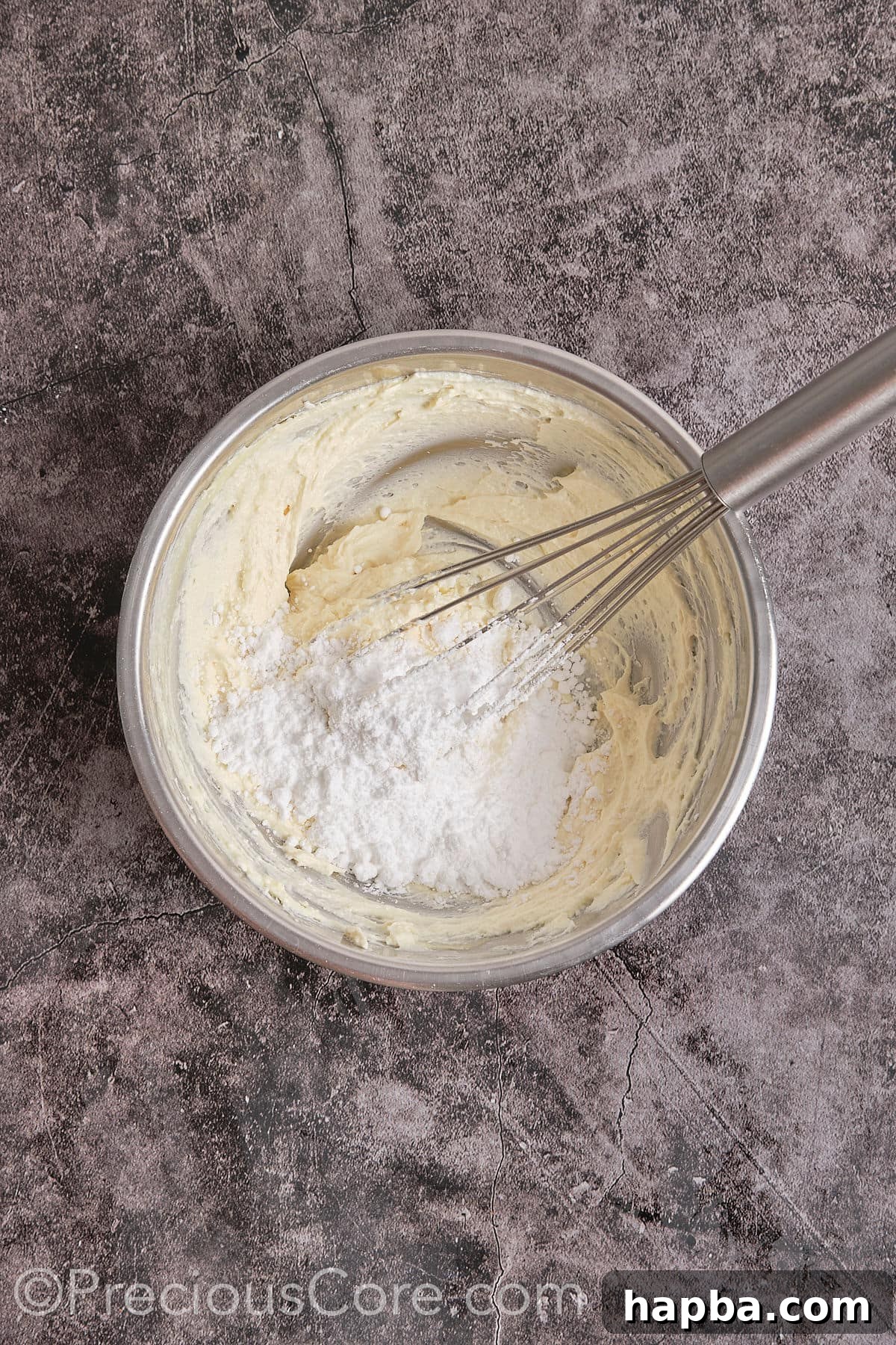 Decadent Butter Pecan Pound Cake 15 Adding powdered sugar to the cream cheese and butter mixture, beating until smooth and creamy.