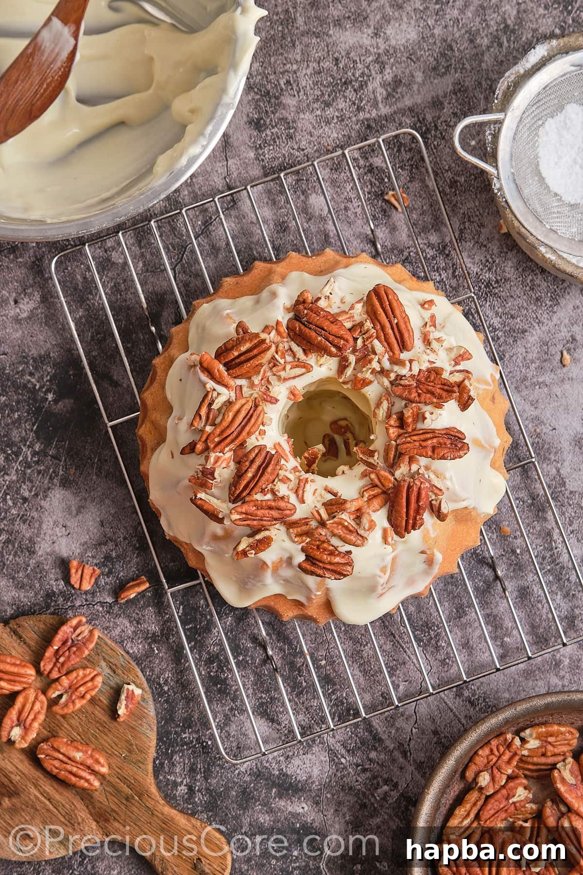 Decadent Butter Pecan Pound Cake 17 Garnishing the frosted pound cake with whole pecan nuts for a beautiful finish.