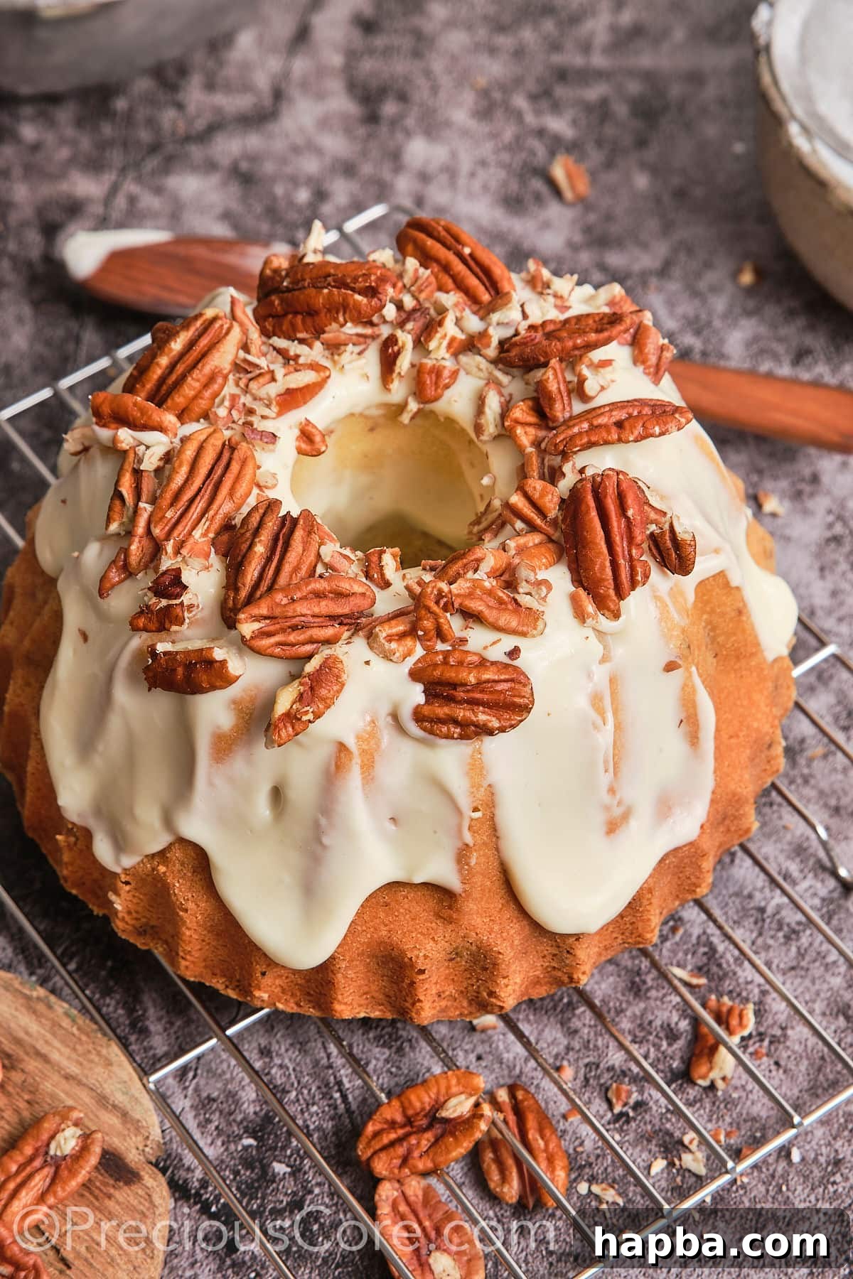 Decadent Butter Pecan Pound Cake 3 A whole butter pecan pound cake generously covered with creamy frosting and decorated with pecans.