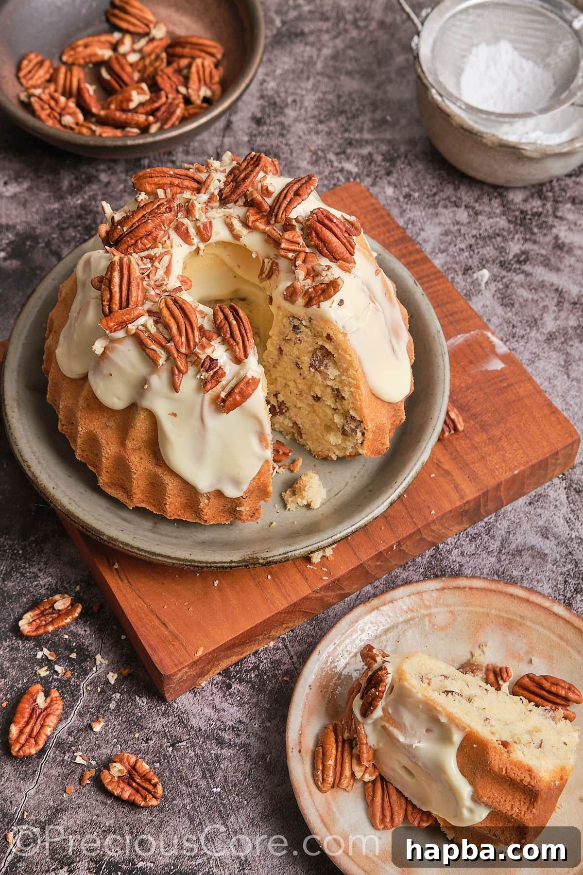 Decadent Butter Pecan Pound Cake 4 A delicious slice taken out of a butter pecan cake with a generous layer of cream cheese frosting.