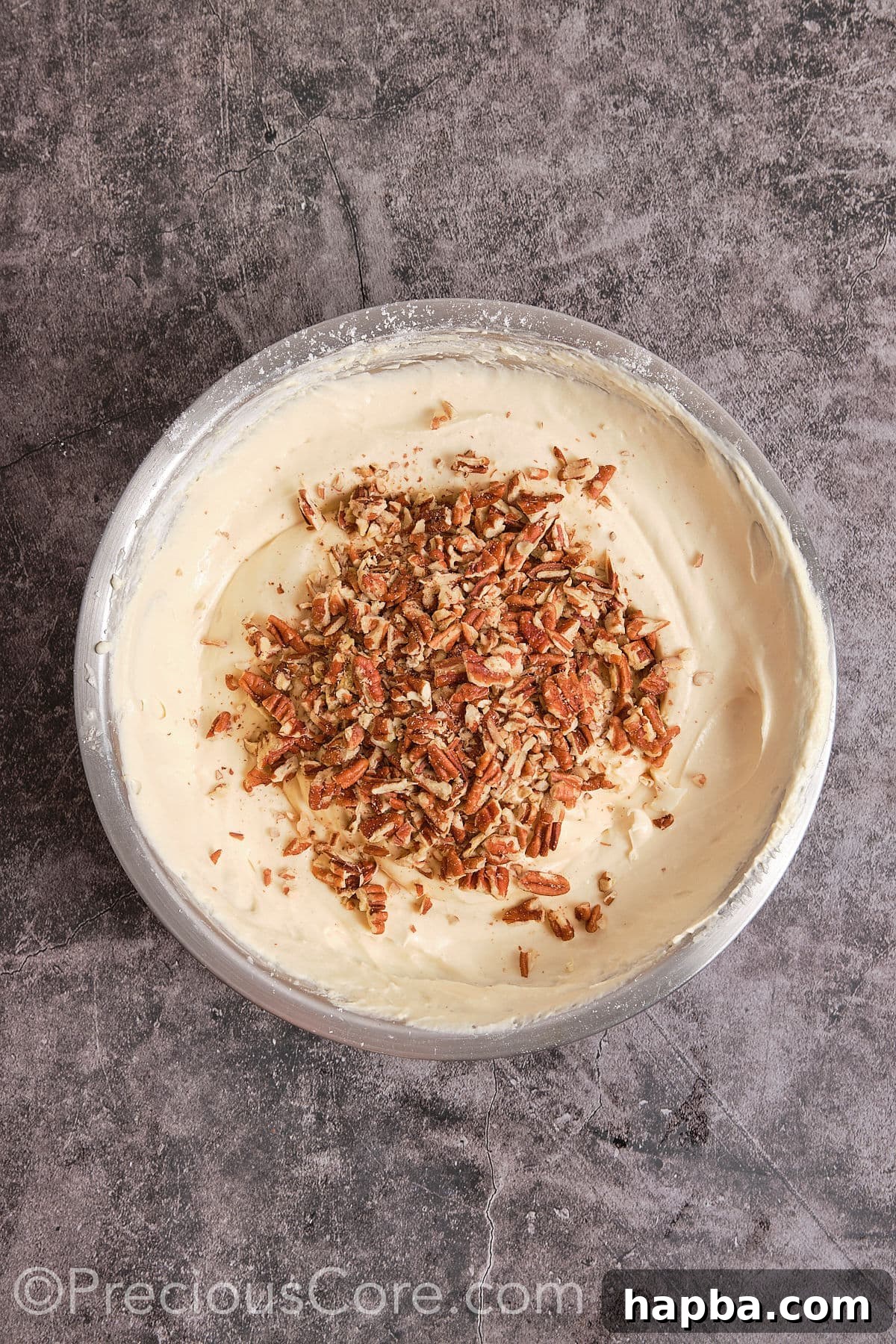 Decadent Butter Pecan Pound Cake 10 Folding chopped pecans into the cake batter until evenly distributed.