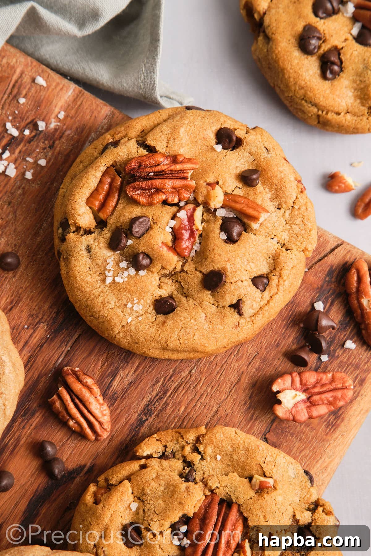 Crispy and chewy brown butter pecan cookies on a chopping board. 