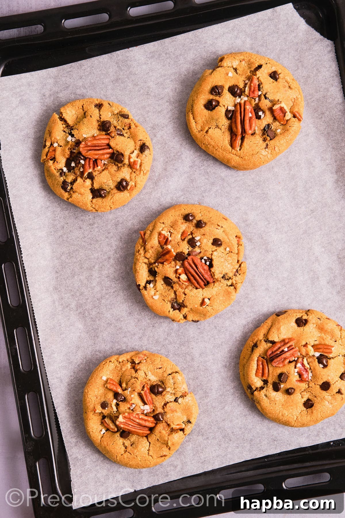 Perfectly baked brown butter pecan cookies on a baking sheet. 