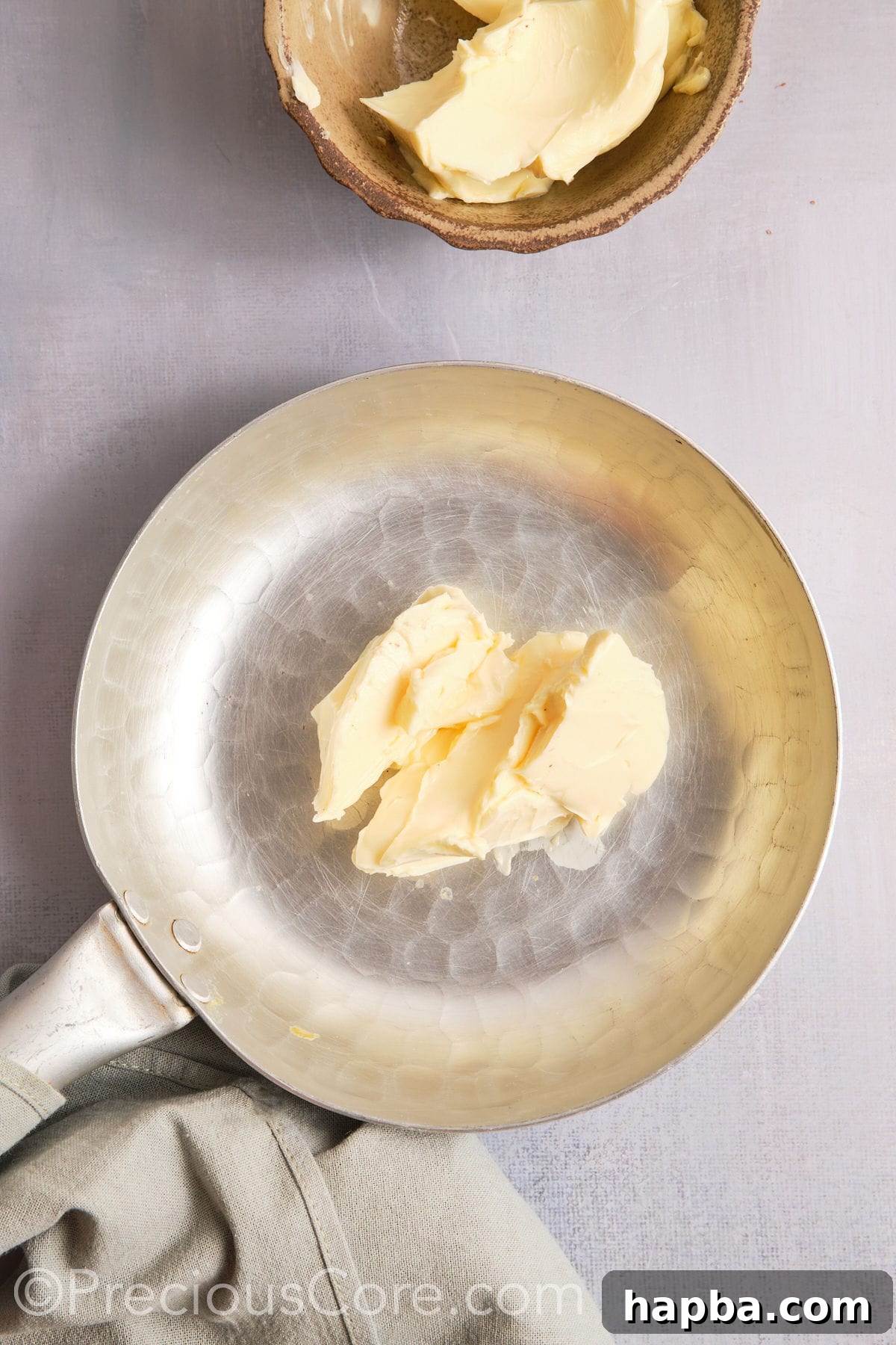Butter in a pan about to melt and brown.
