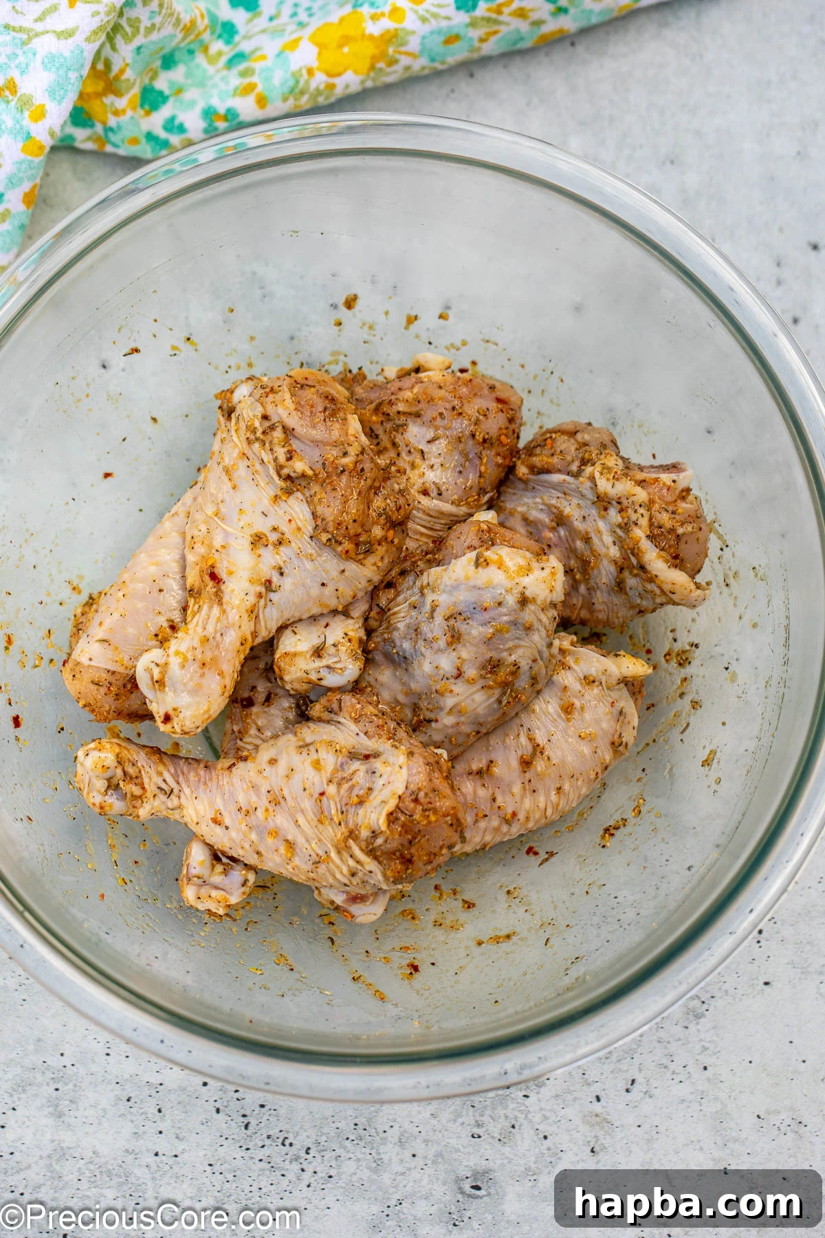 Golden Lemon Pepper Drumsticks 7 Chicken drumsticks thoroughly rubbed with seasoning, ready for baking.