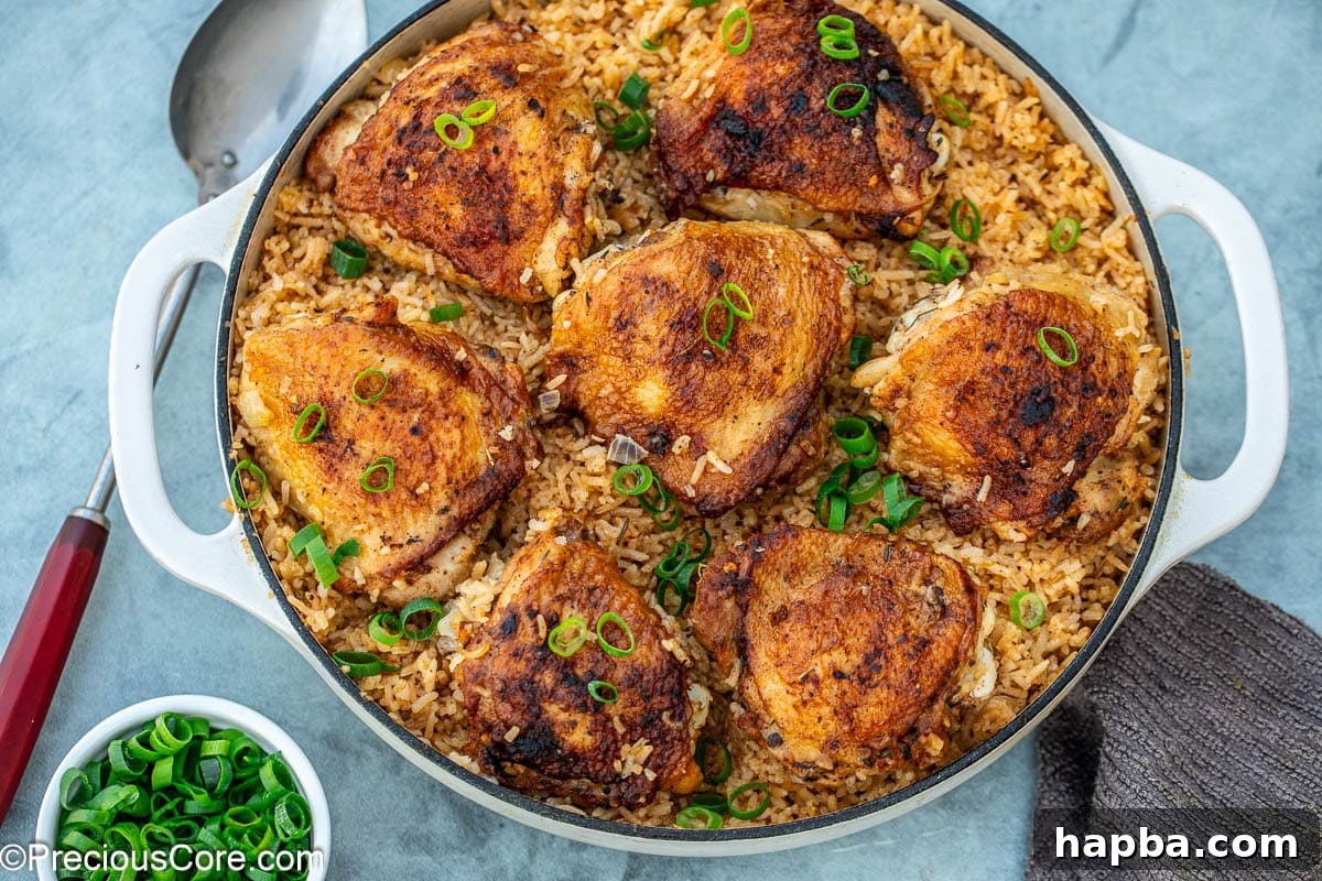 chicken thighs and rice cooked in a pot.