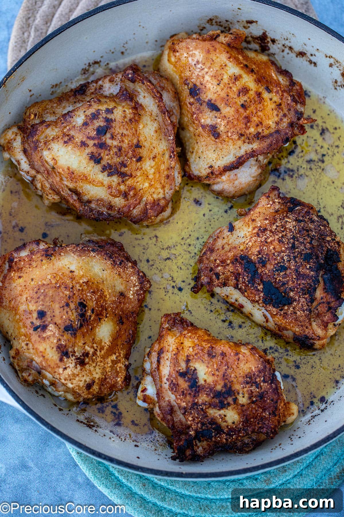 marinated chicken seared in a pan.