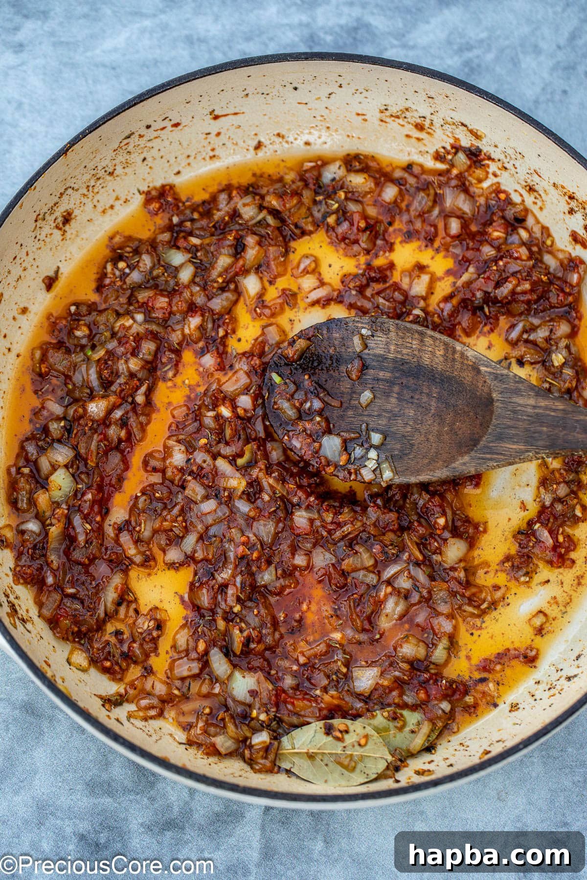 adding tomato paste to the pan.
