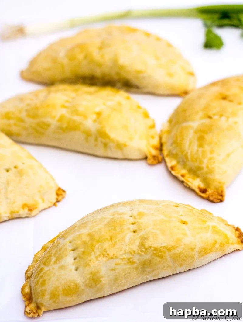 The Ultimate Cameroonian Fish Pie Video Recipe 2 Delicious, golden-brown Cameroonian fish pies cooling on a rack
