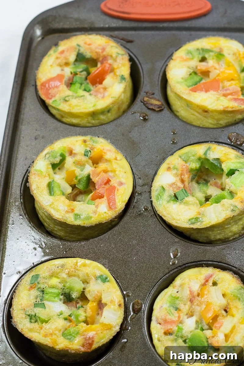 Quick and Healthy Egg Cups 3 Close-up view of perfectly baked breakfast egg muffins in a muffin tin, ready to be served.