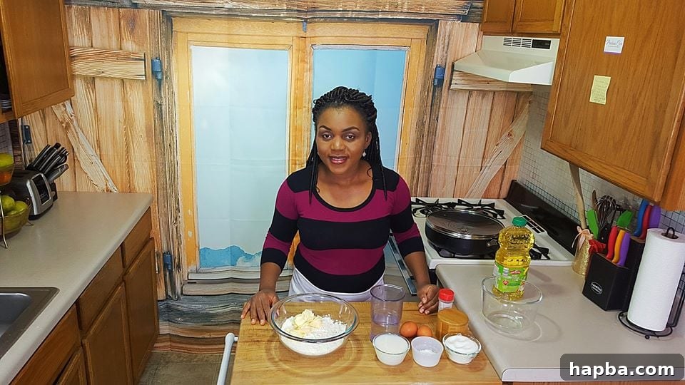 Blogger Precious in her kitchen in 2017, showcasing cooking space with a vibrant new backdrop