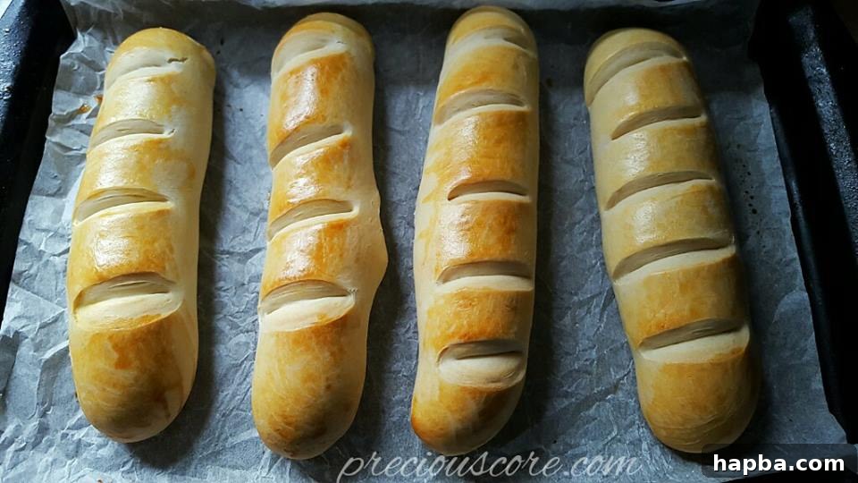 Freshly baked homemade milk bread (pain au lait) on a cooling rack, golden brown and fluffy.