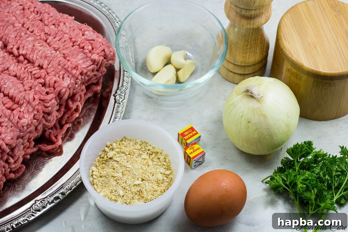 African Spiced Meatballs 3 A selection of fresh ingredients including ground beef, garlic, onions, parsley, and spices, laid out for meatball preparation.