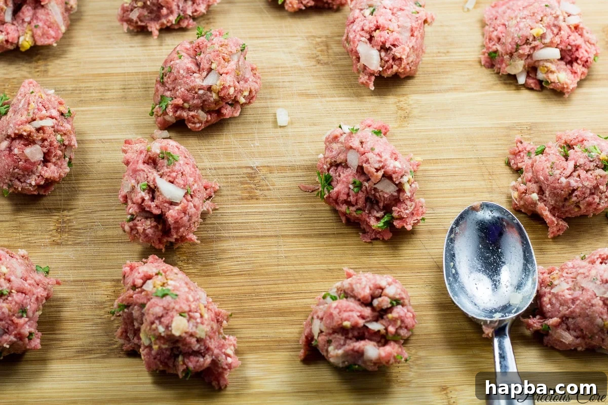 African Spiced Meatballs 6 Using an ice cream scoop to portion meatball mixture for even sizing.