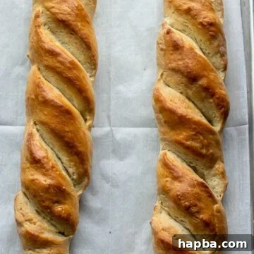 French bread loaves on large baking sheet, freshly baked and ready for serving