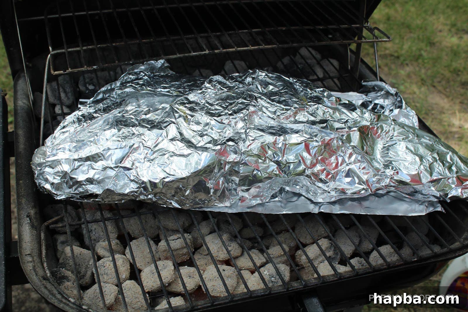 Foil-wrapped fish on grill