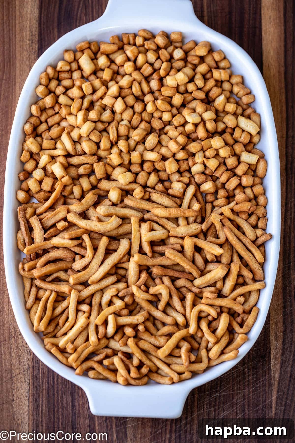 Chin chin on a white tray, showcasing its golden-brown crispiness.