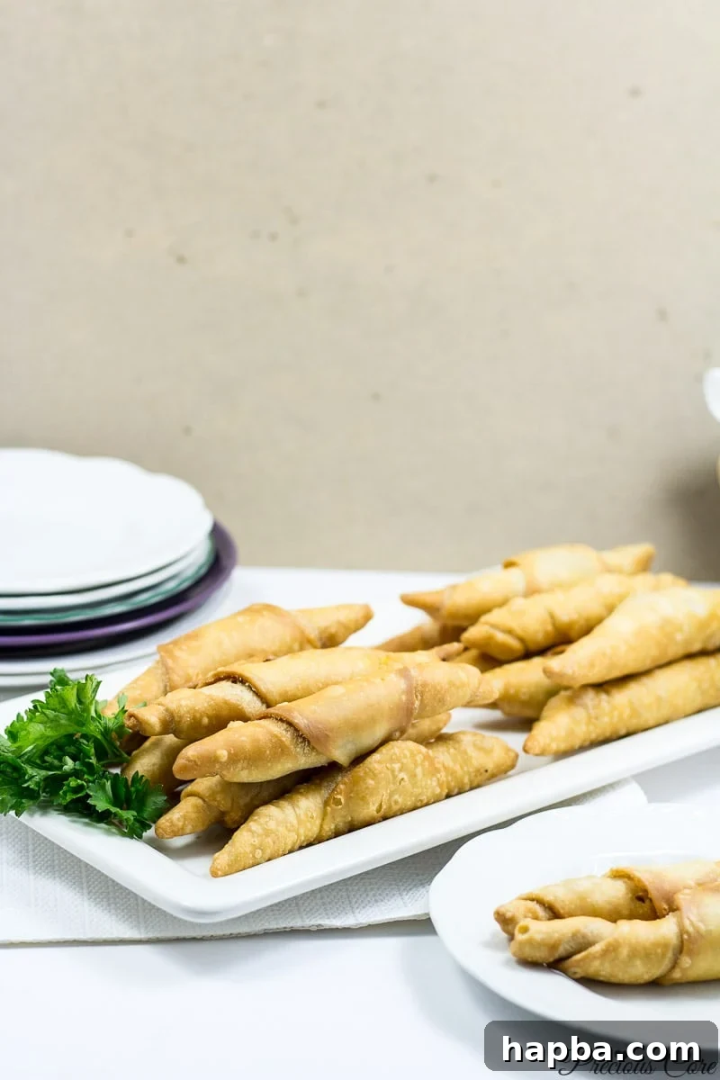 Crispy African Fish Rolls: Golden-brown pastries on a plate, showcasing the delectable snack