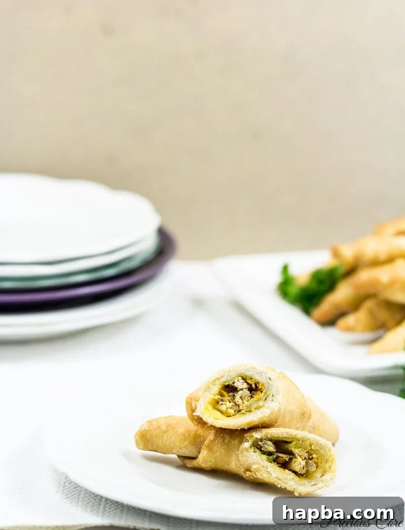 Savory Cameroonian Fish Rolls 17 Close-up of a cut Cameroonian fish roll, revealing its rich and flavorful sardine and vegetable filling.