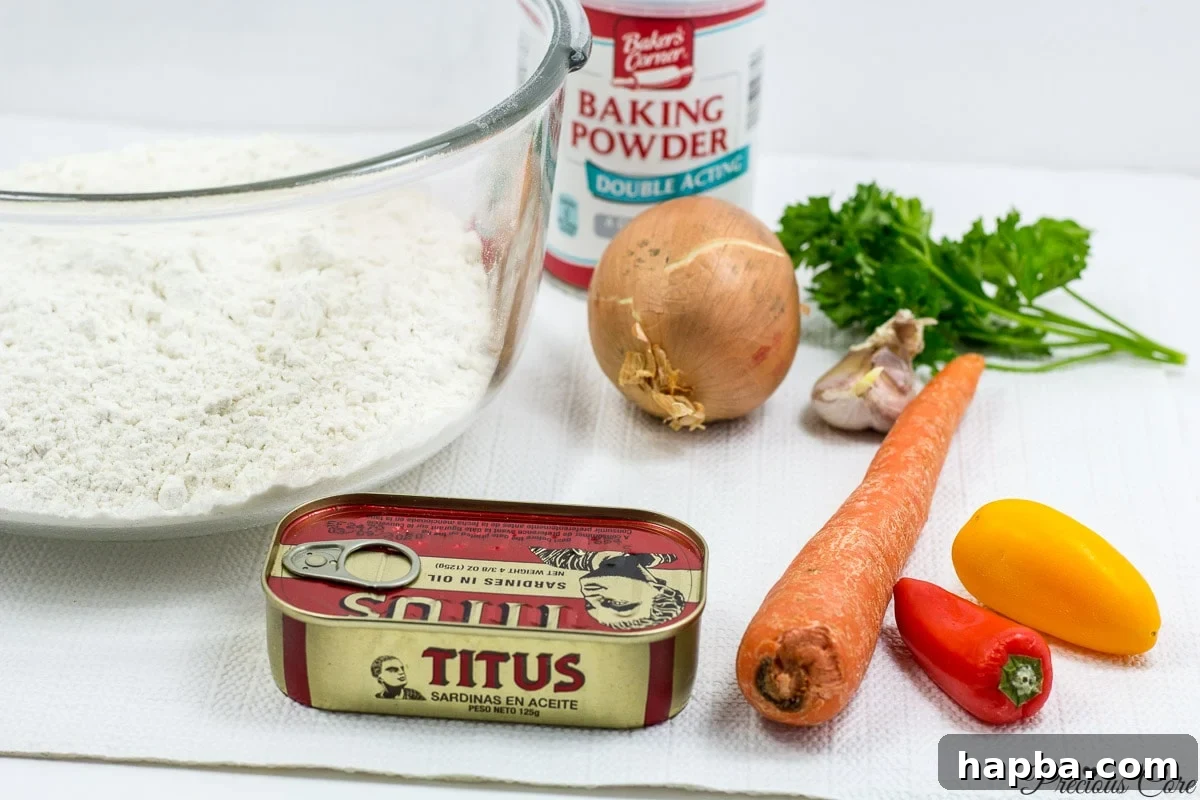 Savory Cameroonian Fish Rolls 3 cameroon fish roll ingredients including sardines, vegetables, flour, and oil, ready for preparation.
