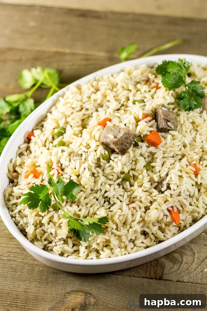 A beautifully presented bowl of authentic Cameroonian Coconut Rice, garnished and ready to serve.