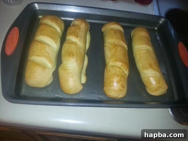 Simple Homemade Milk Bread 2 Freshly baked homemade milk bread loaves, golden brown and inviting