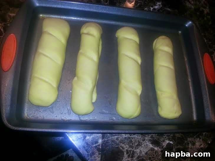 Simple Homemade Milk Bread 10 Milk bread loaves after their second rise, appearing visibly puffy and expanded