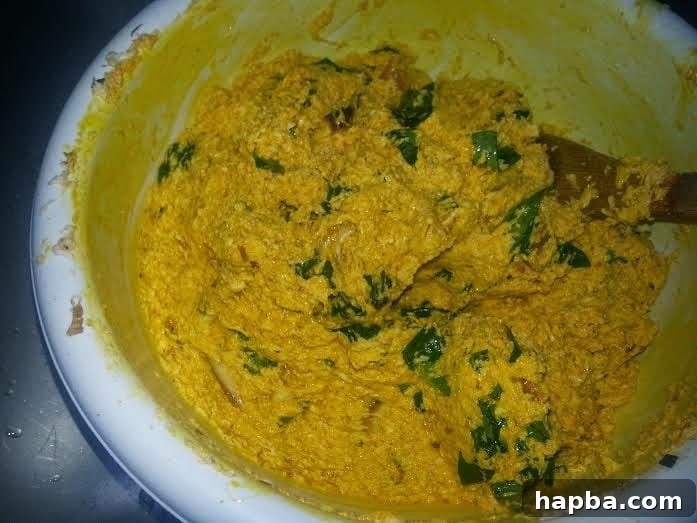 Palm oil mixed into cocoyam paste, achieving even reddish-orange color
