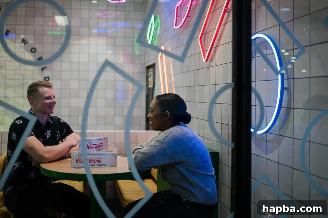 A man and woman sharing a moment, sitting closely and smiling in a stylish store setting, highlighting connection and interaction.