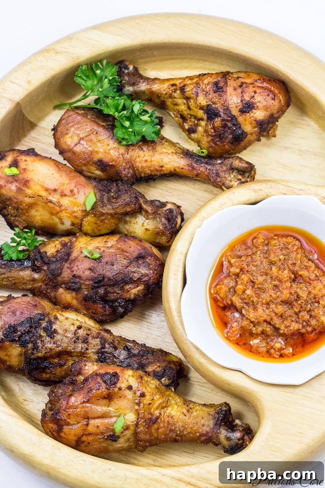 Close-up of a perfectly oven-grilled chicken drumstick, showing its crispy, golden-brown skin and succulent texture, ready to be served.