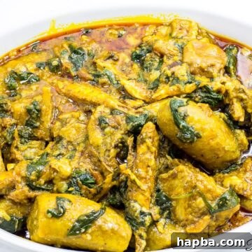 Large bowl of Cameroonian plantain porridge, garnished and ready to serve.